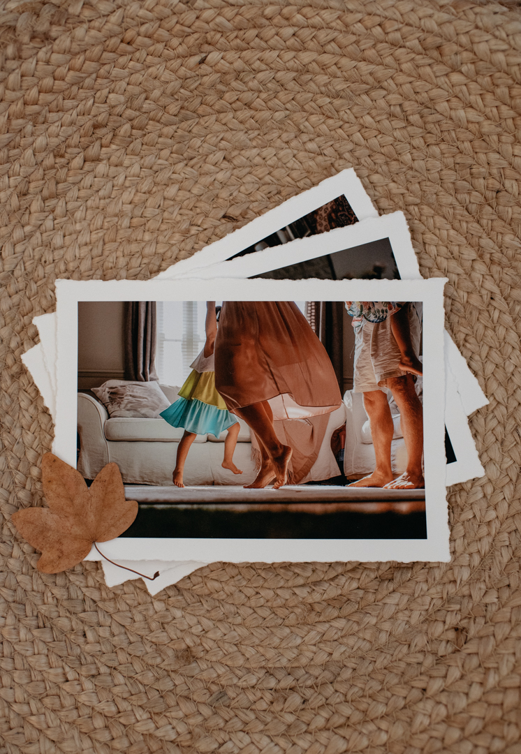 Printed photographs of a family dancing together by Agi Lebiedz